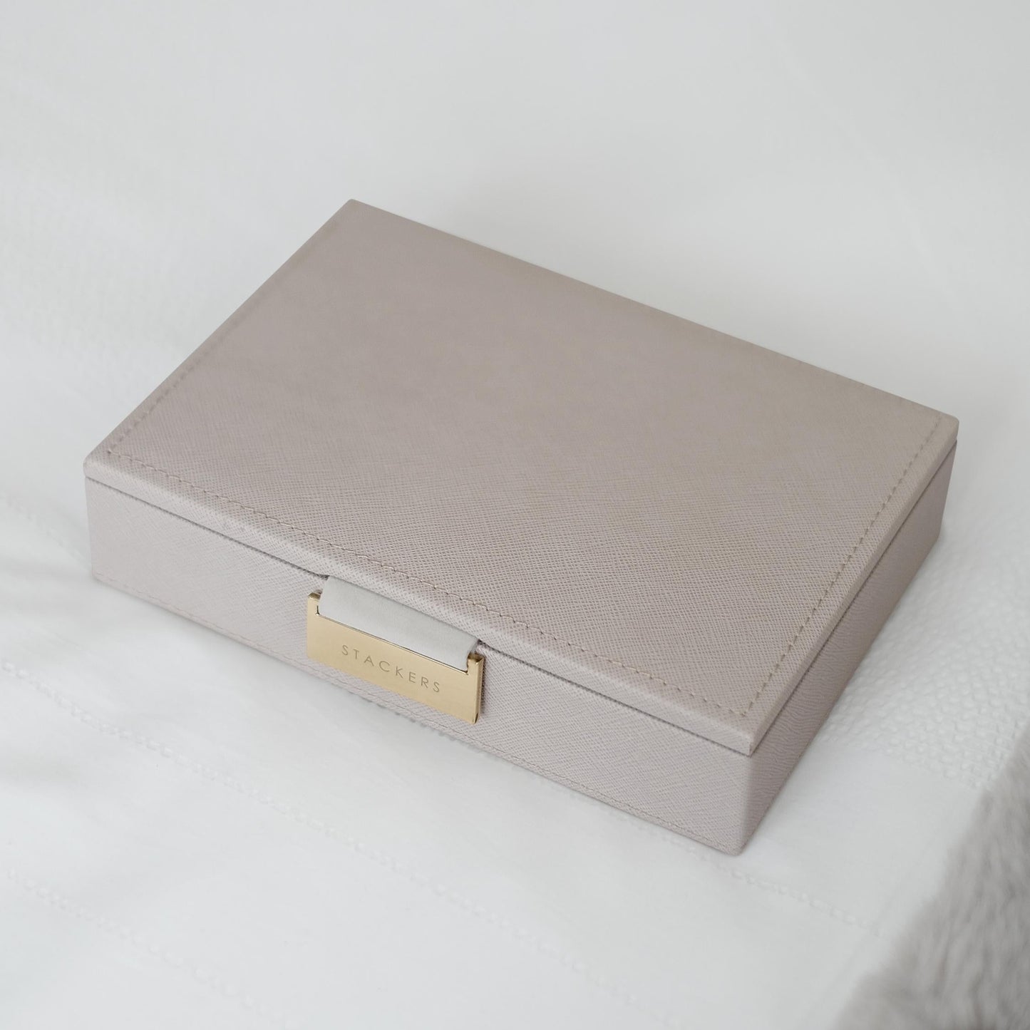 Gray jewelry box with gold tag on a white background at coe and co 